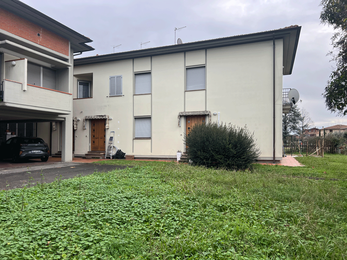Retro della struttura della caserma con ingressi indipendenti e aree a verde.